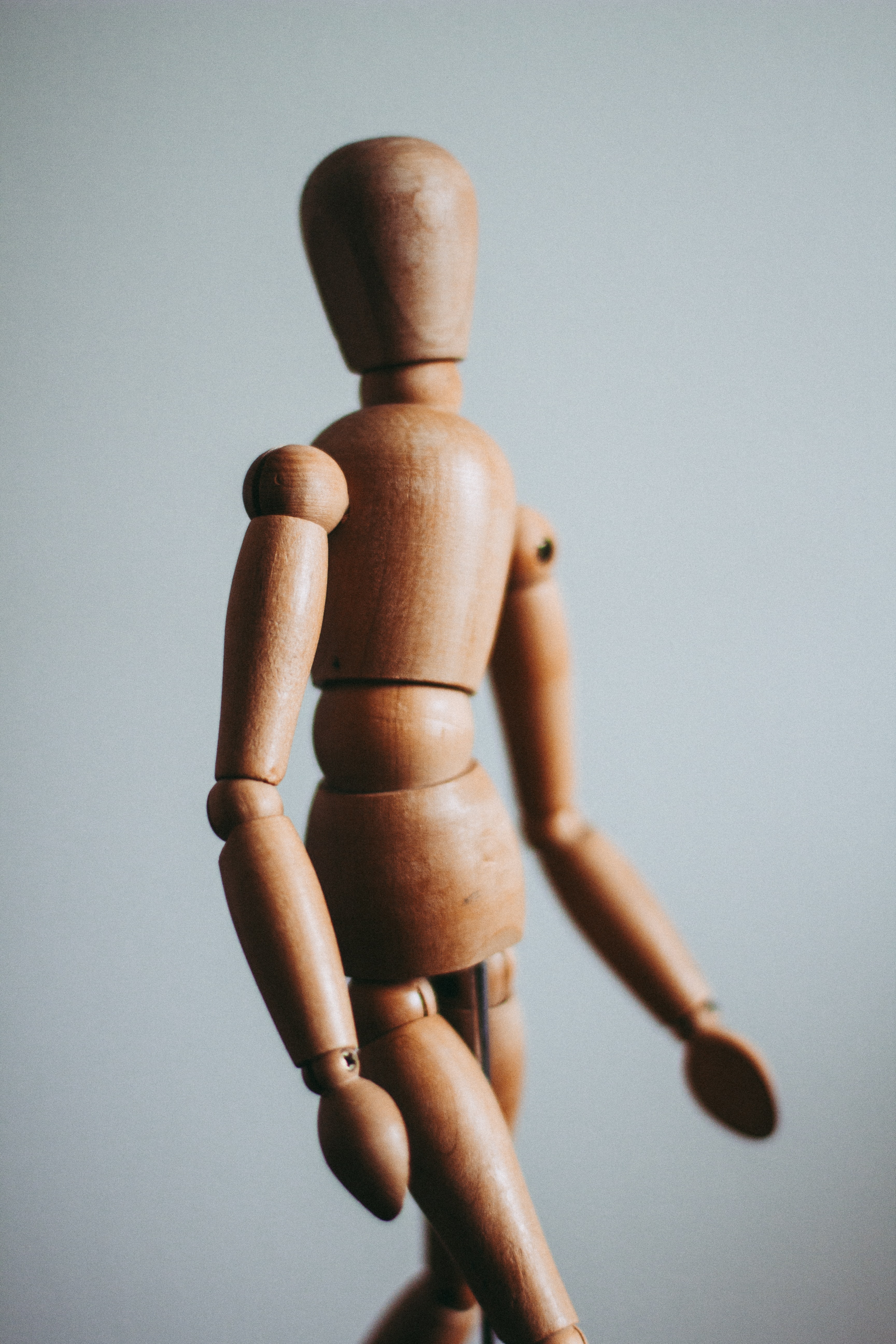 Wooden figure of human with postural distortion. Wooden human figure
